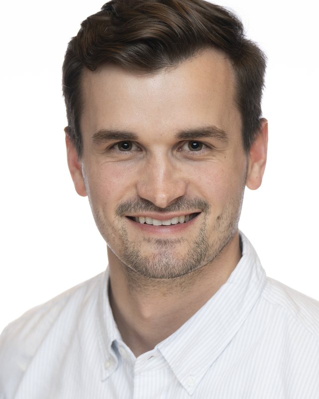 Corporate headshot on a white backdrop, shot at a Fate Media Creative booth