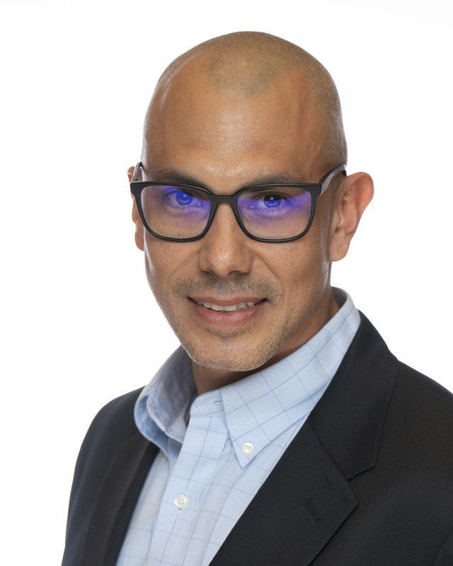 Corporate headshot on a white backdrop, shot at a Fate Media Creative booth