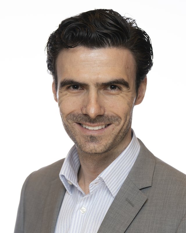 Corporate headshot on a white backdrop, shot at a Fate Media Creative booth